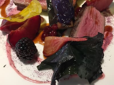 Plated seared beef with seasonal garnishes