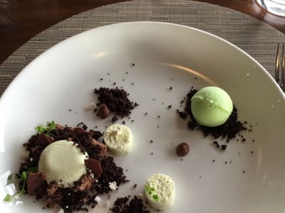 Deconstructed pistachio dessert on white plate