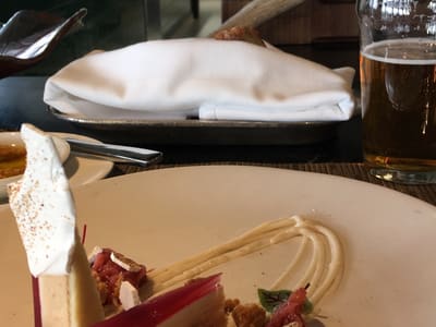 Plated dessert and beer at open kitchen