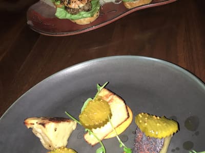 Mini burger sliders on a dimly lit table
