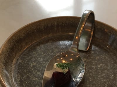 Minimalist amuse-bouche on spoon and plate
