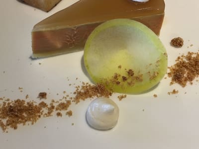 Plated caramel tart dessert on white plate