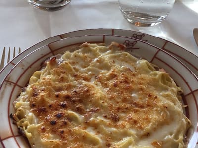 Cheesy Baked Pasta at Restaurant Table
