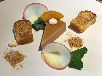 Minimalist plated caramel tart with garnishes