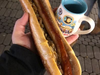 Extra long bratwurst and mug at market