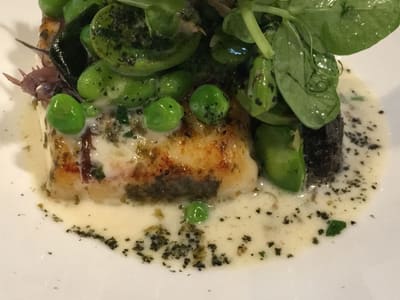 Seared fish with peas in fine dining