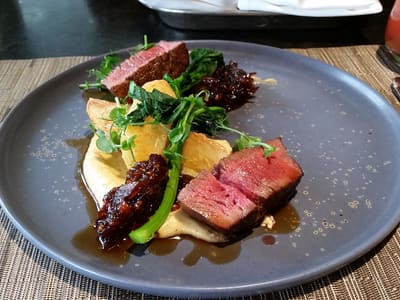 Plated medium-rare steak with potatoes