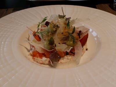Gourmet plated salmon starter on white china