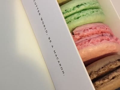 Colorful macarons in a boxed tray