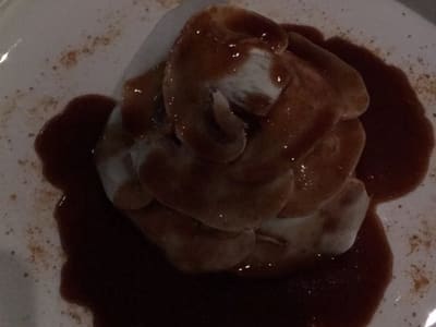 Sauced plated dessert in dimly lit restaurant