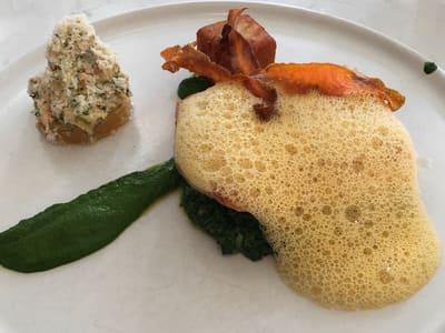 Plated seafood entree at marble counter