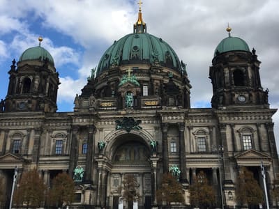 Berlin Cathedral façade under cloudy sky
