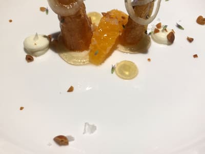 Plated gourmet carrot amuse-bouche on white