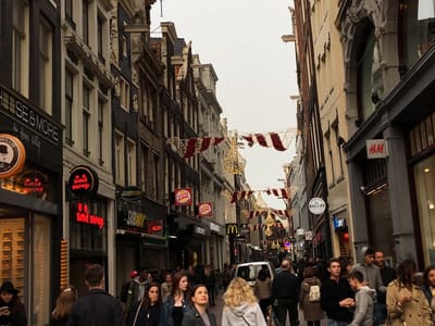 Crowded European shopping street under decorations