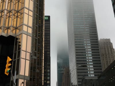 Fog-shrouded downtown street with skyscrapers